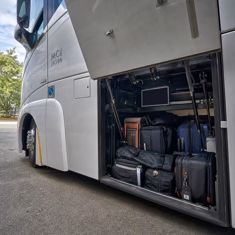 Party bus interior with wraparound leather seating and LED lighting in Glendale