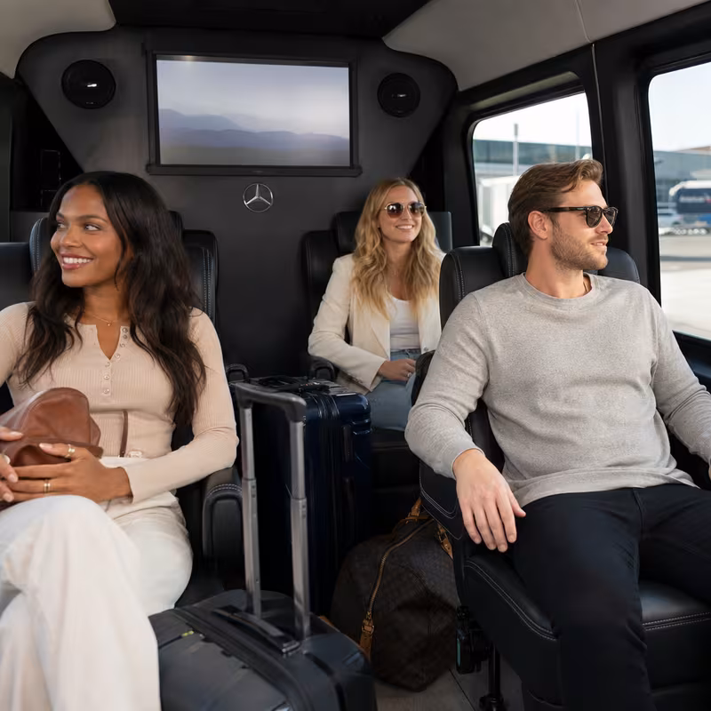 Passengers loading luggage while boarding an Glendale group shuttle