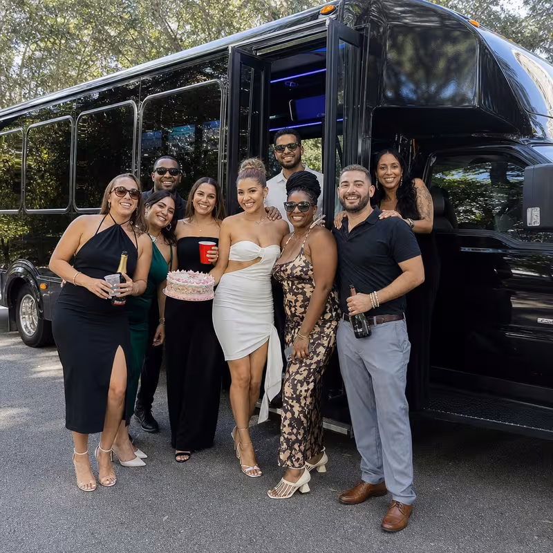 Group boarding a white charter bus for Birthday Transportation transportation in Glendale