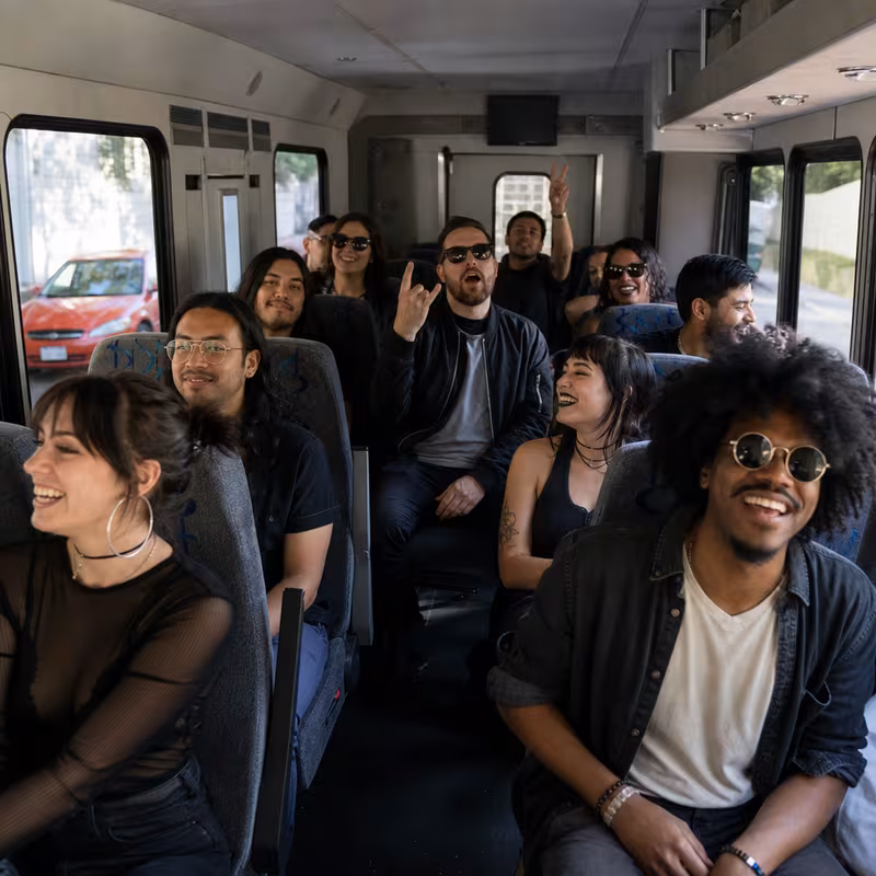 Party bus interior with wraparound leather seating and LED lighting in Glendale