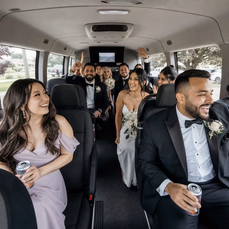 Group boarding a white charter bus for Wedding Transportation transportation in Glendale